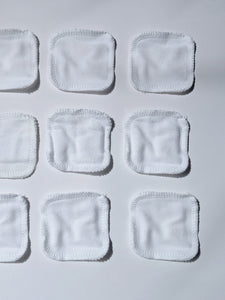 white cotton facial rounds laid out next to each other