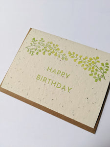 a plantable seed card - the card has a textured look from the seeds imbedded in the paper. There is a leaf drawing on this one that says "HAPPY BIRTHDAY"