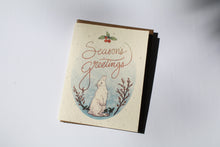 Load image into Gallery viewer, a plantable seed card - the card has a textured look from the seeds imbedded in the paper. There is a bunny drawing on this one that says "Season's Greetings