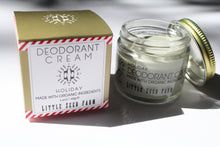 Load image into Gallery viewer, a small jar of cream deodorant. It is in a glass jar with a tin lid. it is next to the box it comes in that says "Deodorant cream - holiday. made with organic ingredients."