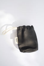 Load image into Gallery viewer, A close up look at the pop bag holder that is a gray color. It has a soft cotton handle and a small tag on the side that says "100% plastic free made in USA"
