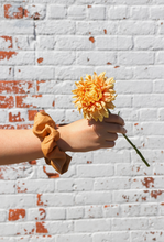 Load image into Gallery viewer, someone holding a large flower with a silk scrunchie on their wrist
