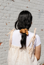 Load image into Gallery viewer, a close up of a girl wearing an orange colored silk scrunchie