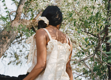 Load image into Gallery viewer, a close up of a girl wearing a cream colored silk scrunchie