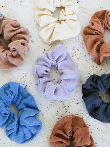 multiple gauze scrunchies laying next to each other varying in color