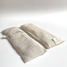Load image into Gallery viewer, two a natural linen eye pillows, one has the slip cover on it, one does not