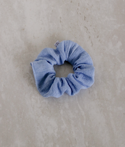 a light blue colored gauze scrunchie