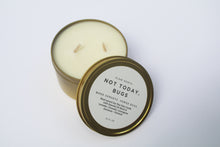 Load image into Gallery viewer, a bug repellent candle with the lid leaning against it