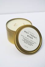 Load image into Gallery viewer, a bug repellent candle with the lid leaning against it