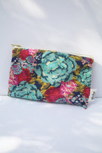 Load image into Gallery viewer, a navy blue colored cosmetic bag with a gold zipper and large floral design