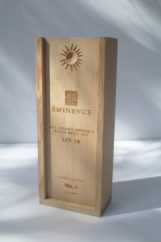 a wooden box containing Sun Defense Mineral Powder, shade Calendula Spice, by Eminence