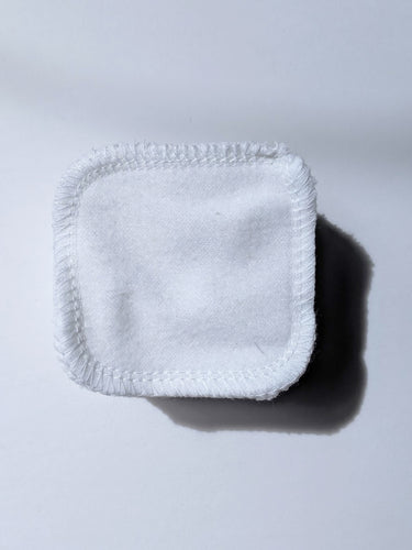 a stack of white cotton reusable facial rounds