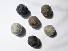 Load image into Gallery viewer, 5 wool dryer balls that are gray varying from light gray to dark gray 
