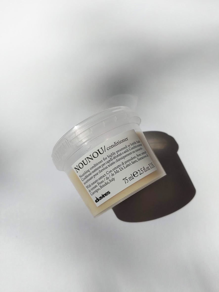 a travel size jar of NOUNOU conditioner by Davines