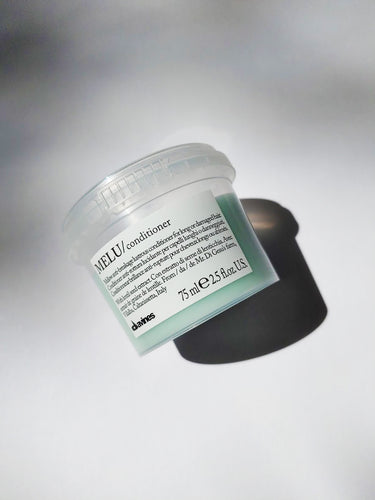 a travel size jar of MELU conditioner by Davines