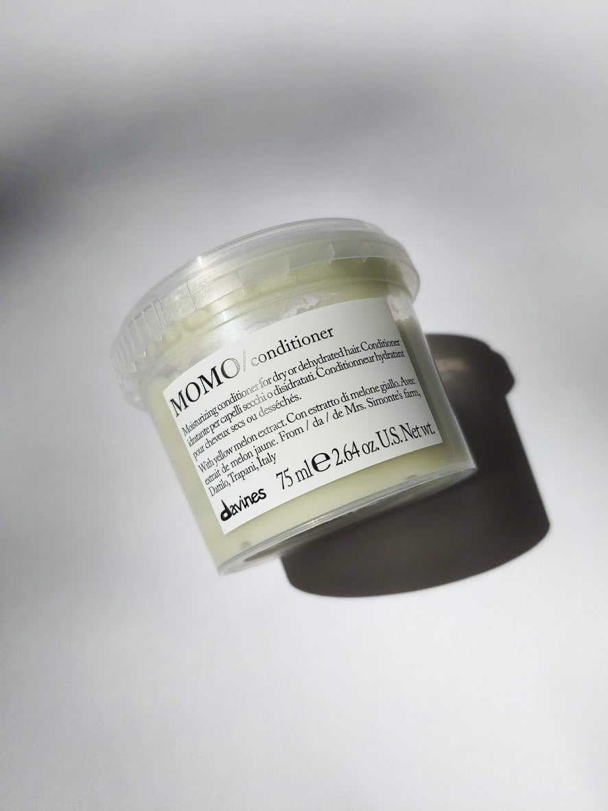 a travel size jar of MOMO conditioner by Davines