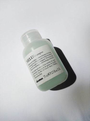 a travel size bottle of MELU shampoo by Davinse
