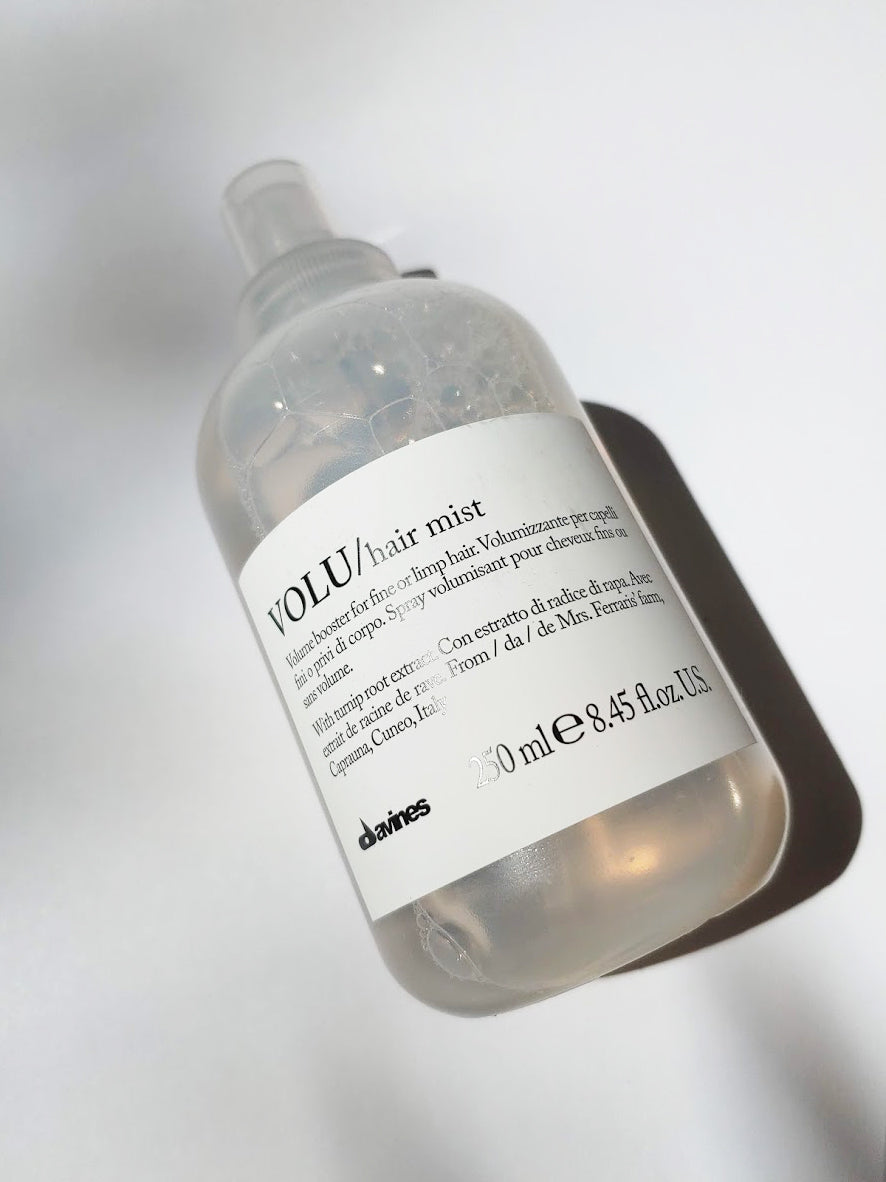 a large bottle of volu hair mist by davines. it is a spray bottle.