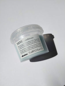 a travel size jar of MINU conditioner by Davines
