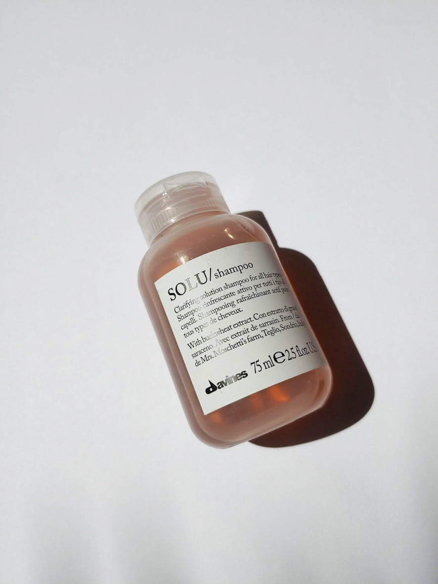 a small bottle of solu shampoo by Davines