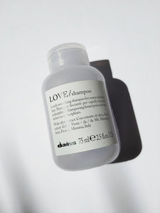a travel sized bottle of LOVE Smoothing shampoo by Davines