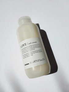a bottle of LOVE curl cream by Davines