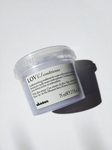 a travel size jar of LOVE Smoothing conditioner by Davines