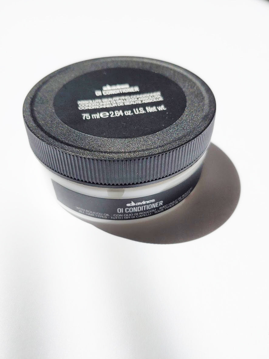 a travel size jar of oi conditioner by Davines