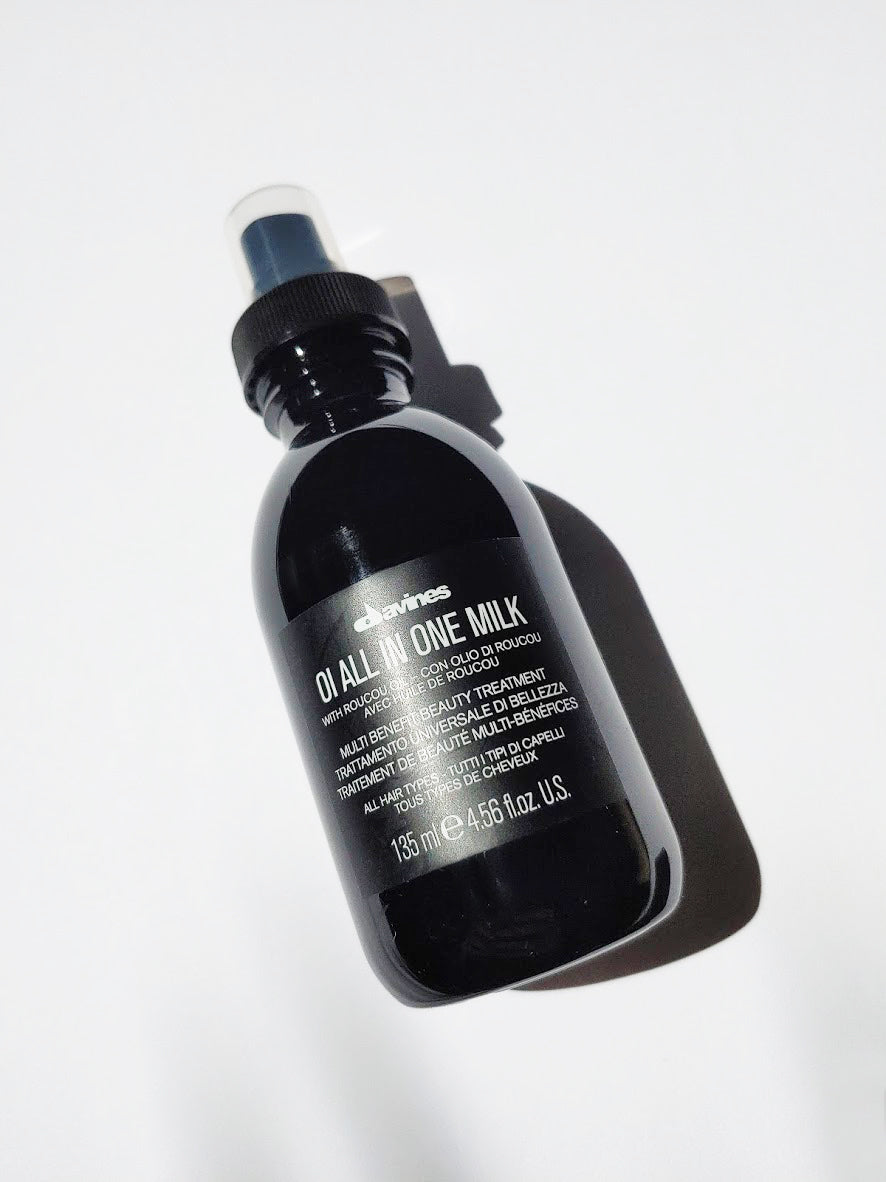 a bottle of oi all in one milk by Davines - the bottle has a spray nozzle