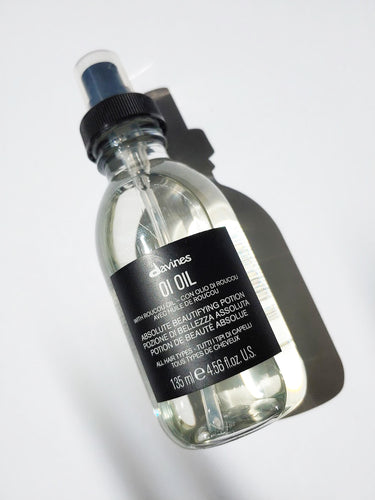 a bottle of oi oil by Davines - the bottle has a pump lid