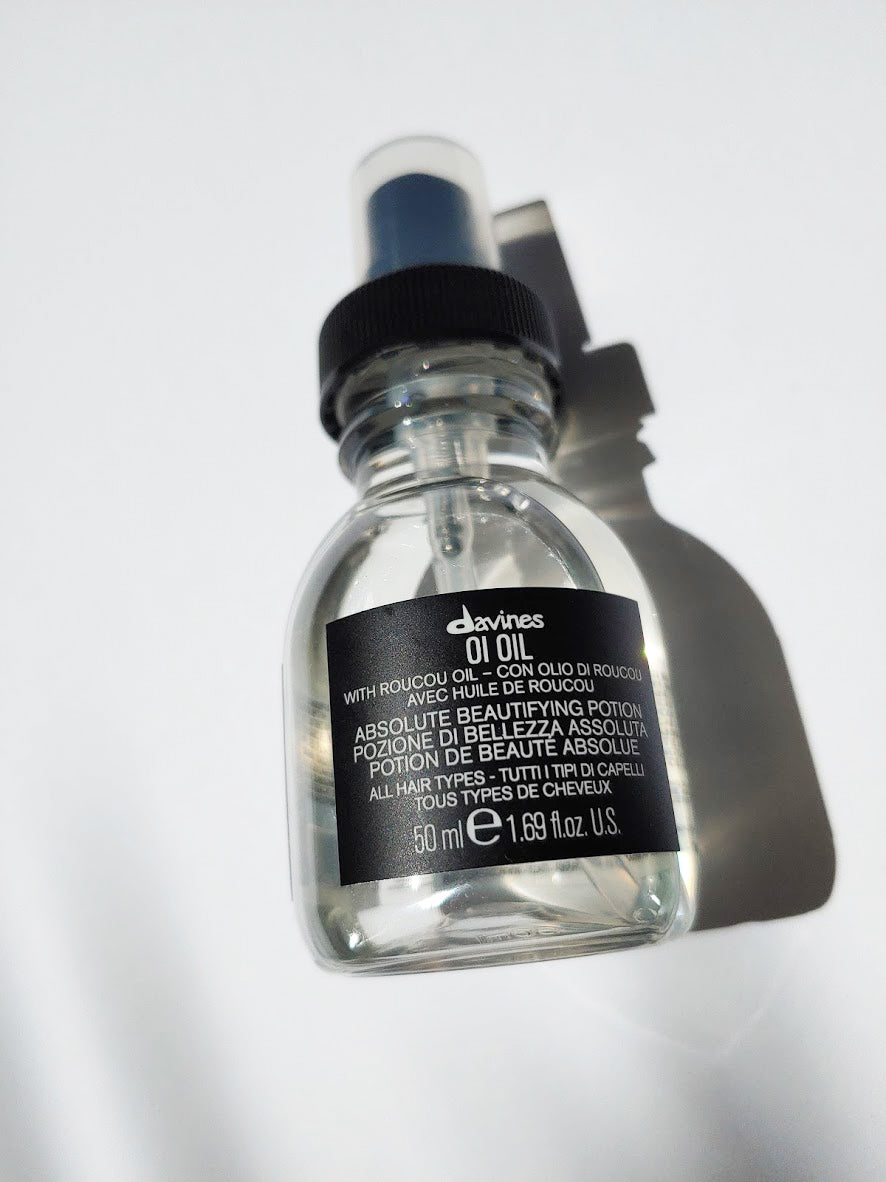 a travel size bottle of oi oil by Davines - the bottle has a pump nozzle