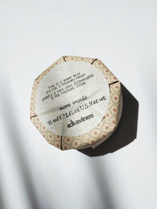 a container of shine wax by Davines