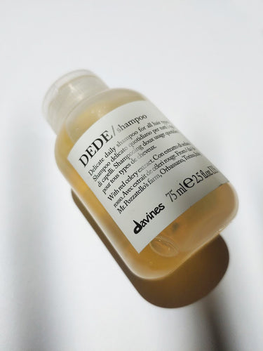a travel size bottle of DEDE shampoo by Davines