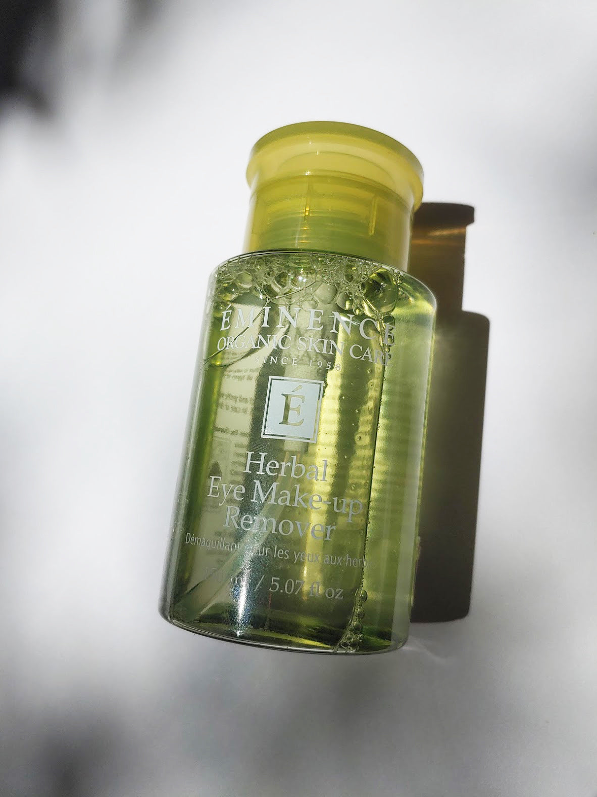 a bottle of the herbal eye mak-up remover by Eminence. The bottle isa bright lime green color.