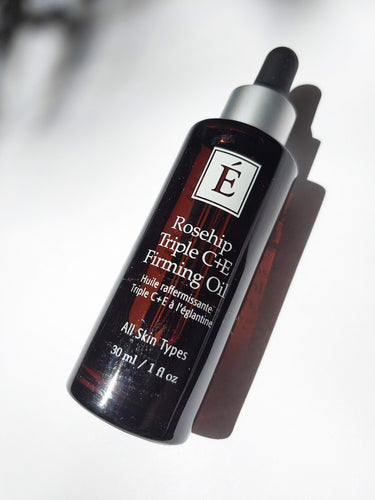 a bottle of rosehip triple c + e firming oil by Eminence - for all skin types. the bottle has an eye dropper top.