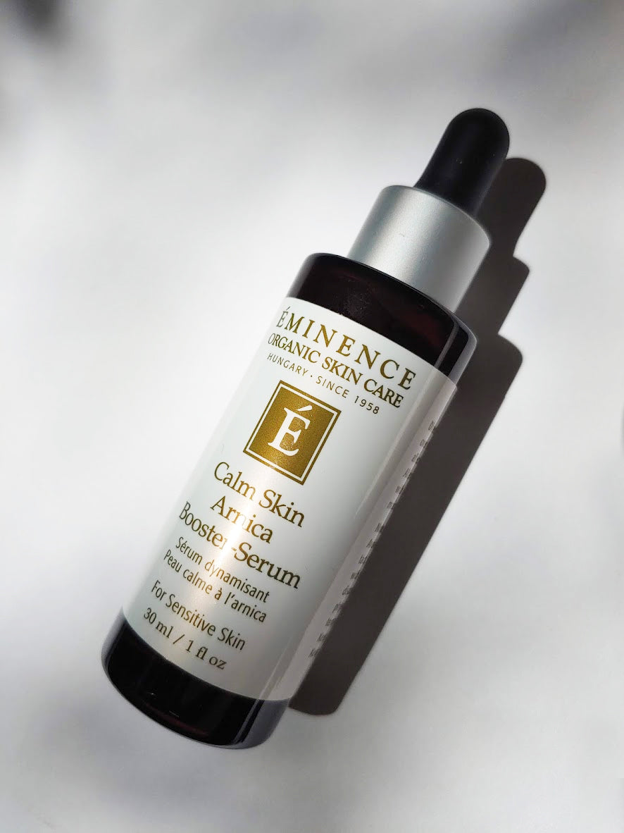 a bottle of the calm skin arnica booster-serum by Eminence. There is a dropper top to the bottle.