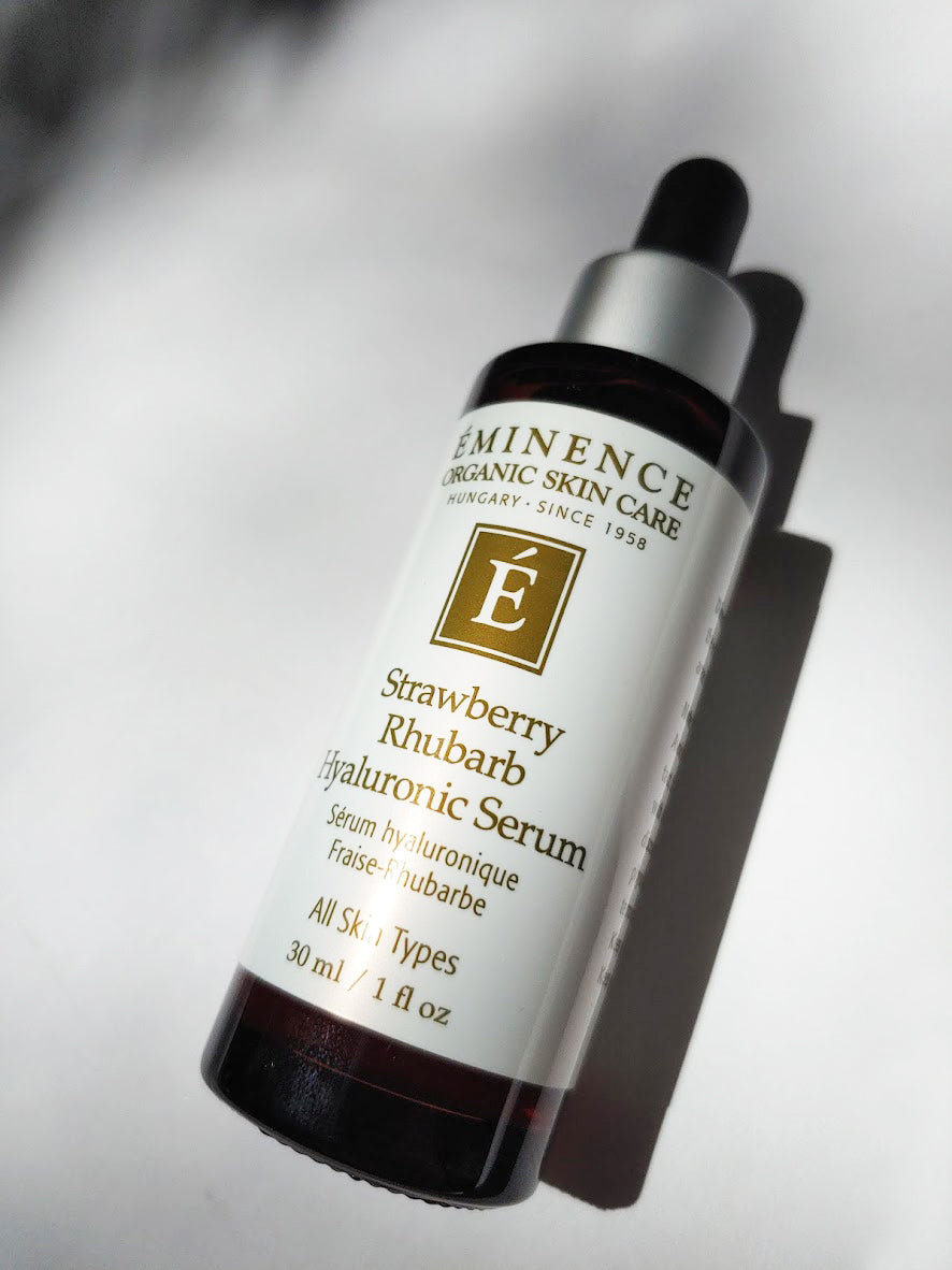 a bottle of strawberry rhubarb hyaluronic serum by Eminence. it has a dropper top to it.