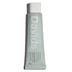 a travel size tube of David's Natural Toothpaste. it says "Premium Natural Toothpaste. Whitening, Antiplaque, Fresh Breath, Flouride Free, Sulfate Free. Peppermint essential oil blend"