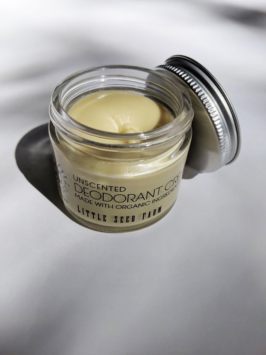 a small jar of cream deodorant. It is in a glass jar with a tin lid.