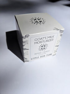 the box the moisturizer comes in that reads "goat's milk moisturizer - repair + renew"