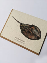 Load image into Gallery viewer, a plantable seed card - the card has a textured look from the seeds imbedded in the paper. There is a horseshoe crab drawing on this one that says &quot;Horseshoe Crab - Limulus Polyphemus&quot;
