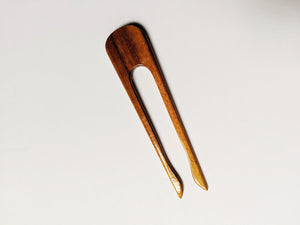 the medium color wooden hair stick