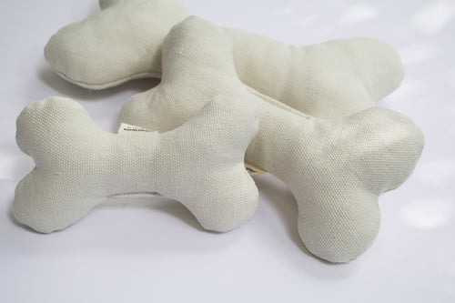 three organic cotton dog bones. They are an off white color.