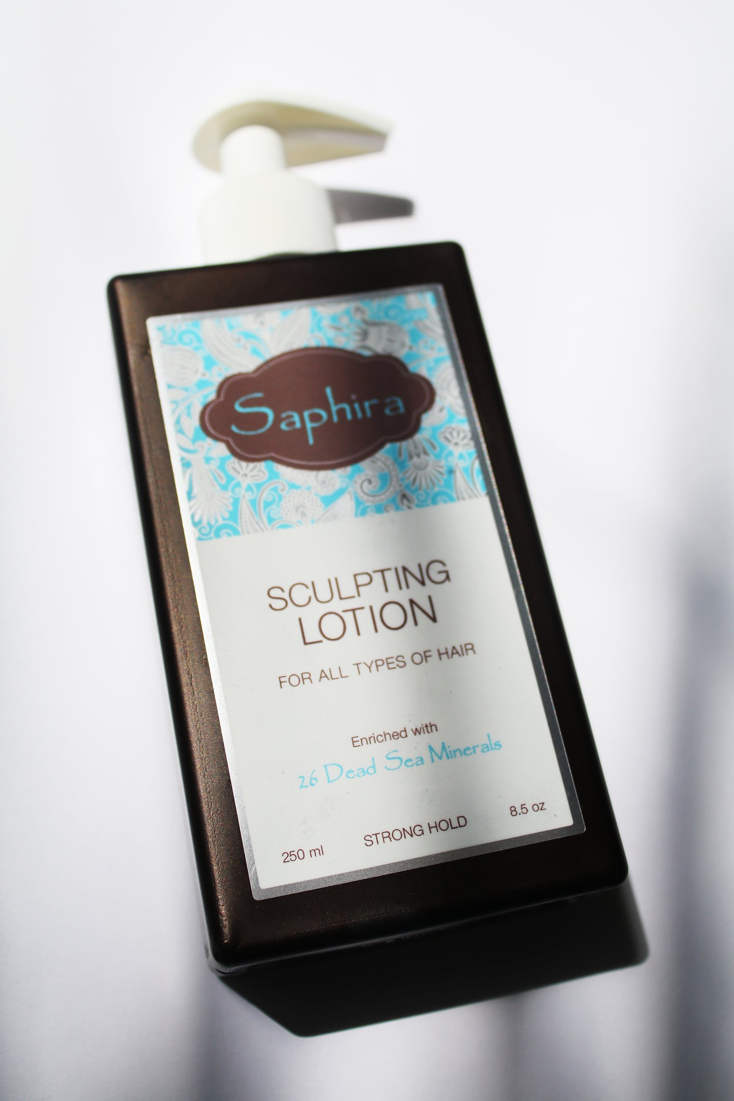 a bottle of sculpting lotion by Saphira. the bottle has a pump top.