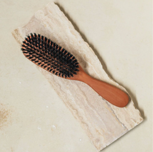 a wooden brush with boar bristles