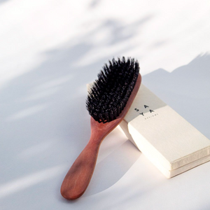 a wooden brush with boar bristles
