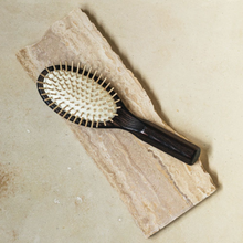 Load image into Gallery viewer, a dark colored wooden hair brush with light wood bristles 
