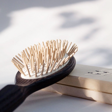 Load image into Gallery viewer, a closer look at the dark colored wooden hair brush with light wood bristles 
