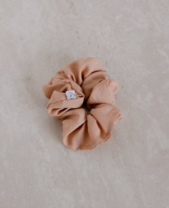 a close up of a rose colored scrunchie