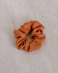 a close up of an orange scrunchie